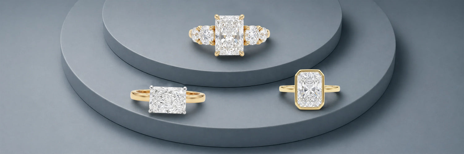 Three radiant cut lab-grown diamond engagement rings in yellow gold — three-stone with oval side stones, classic four-prong solitaire with plain band, and full bezel solitaire on tiered grey stone display