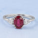 front view of oval red ruby gemstone & heart diamond three stone engagement ring