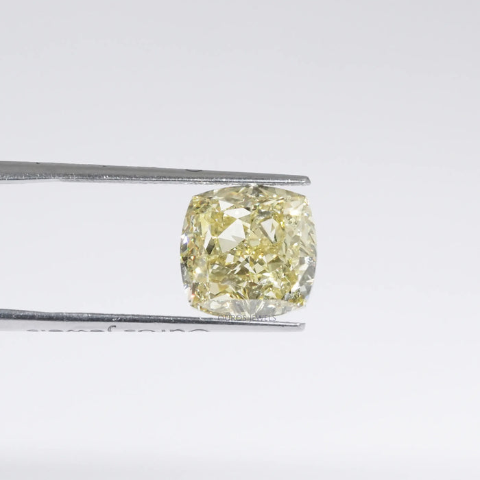 Fancy Yellow Cushion Modified Cut Diamond in a Tweezer 