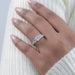 asscher cut diamond five stone engagement ring with white gold band on model's finger