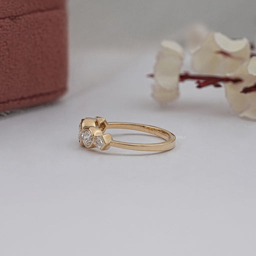 side view of round and pentagon lab diamond bezel set five stone wedding ring