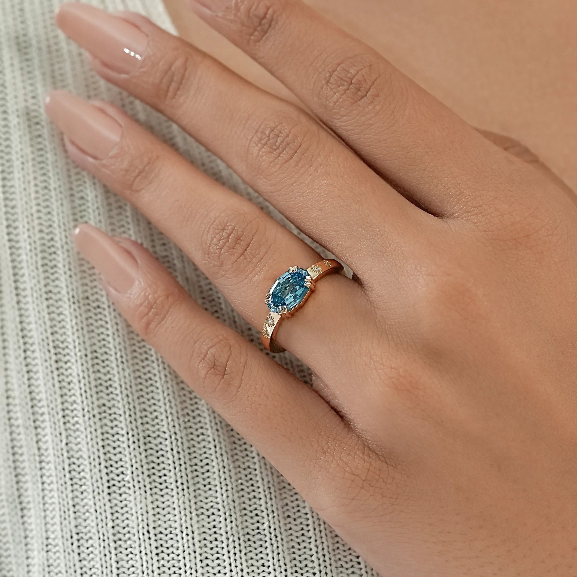 East-West Blue Step Cut Oval Accent Diamond Ring