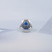blue oval and baguette cut halo gemstone engagement ring's back view