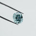 fancy vivid bluish green cushion cut lab made diamond holded with tweezer