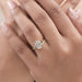 oval-cut lab diamond curved bridal ring set with yellow gold band on model's finger