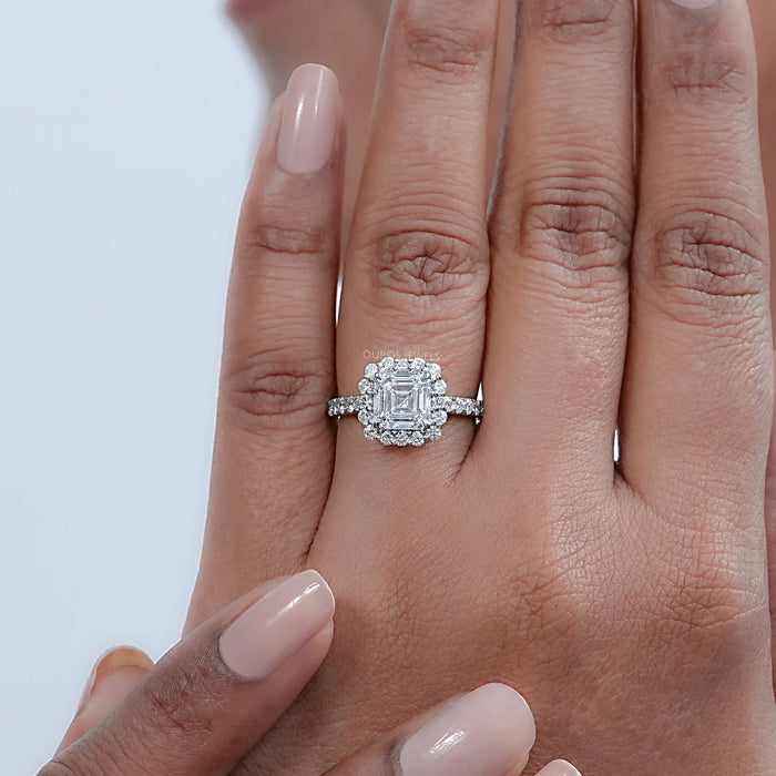 asscher cut lab diamond halo engagement ring on model's finger