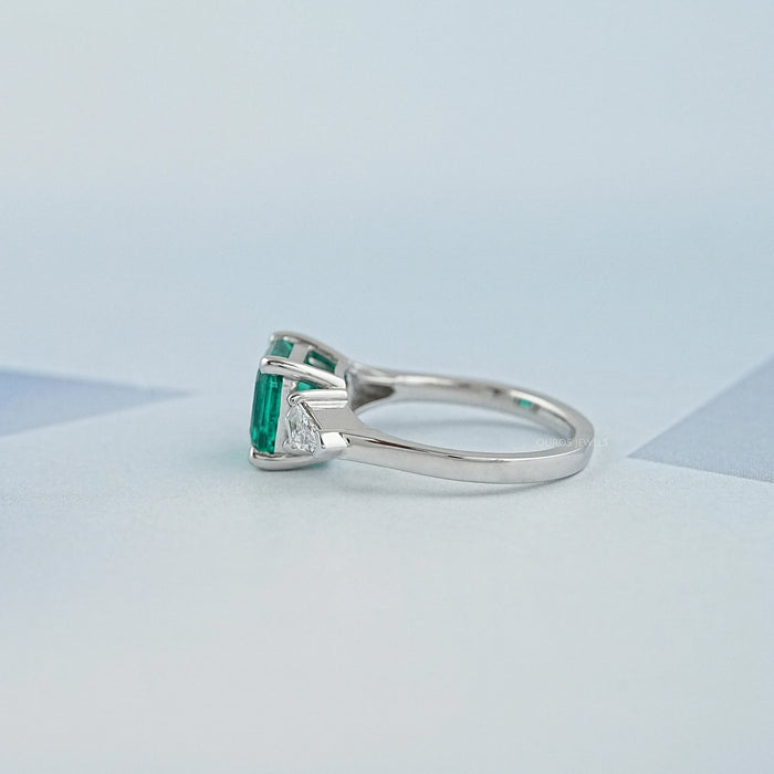 side view of asscher cut green gemstone with bullet diamond 3 stone wedding ring
