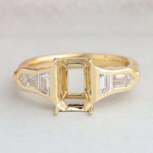 front view of bullet diamond and trapezoid-cut semi-mount engagement ring on fabric