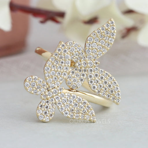 front view of butterfly-shaped round lab diamond bypass cluster engagement ring