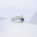 right view of pear cut blue sapphire gemstone cluster bypass engagement ring