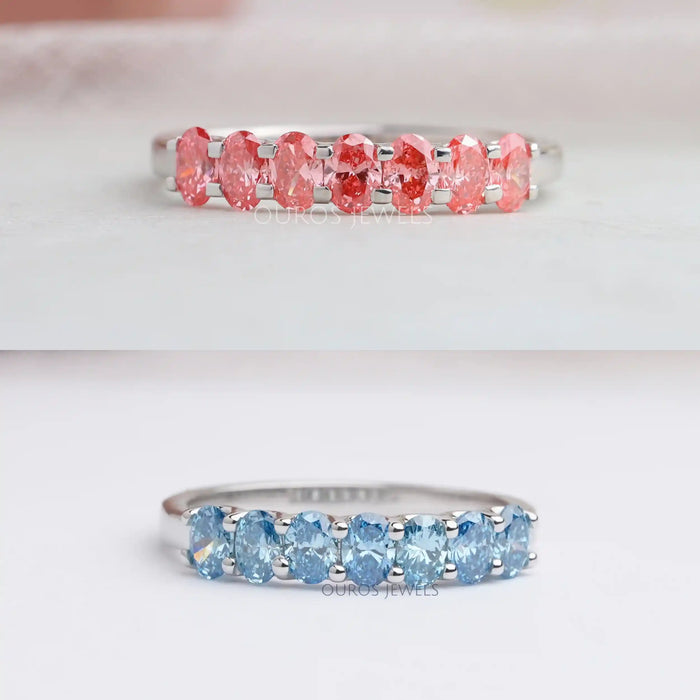 front view of pink and blue oval-cut seven stone lab diamond wedding bands