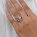 pink cushion-cut lab diamond halo 3 stone colored engagement ring on model's finger