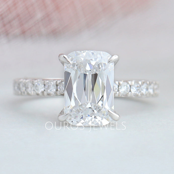 front view of criss-cut lab diamond solitaire accent engagement ring on fabric