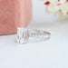 side view of criss-cut lab diamond solitaire accent engagement ring on fabric
