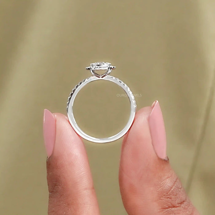 close view of round cut diamond halo crossover engagement ring