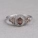 front view of brown cushion cut diamond halo wedding ring on grey fabric