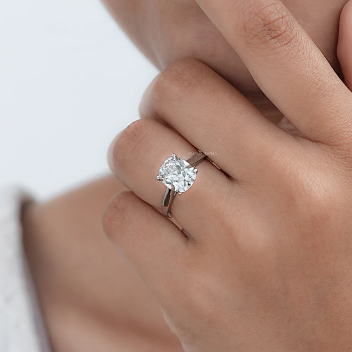 old mine cushion cut lab diamond engagement ring in model's hand