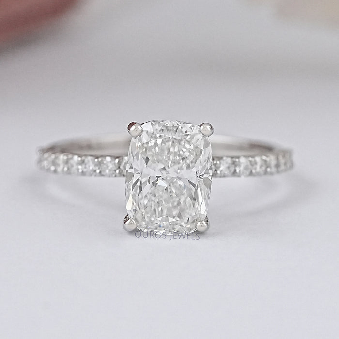front view of cushion-cut lab diamond solitaire accent wedding ring on grey fabric