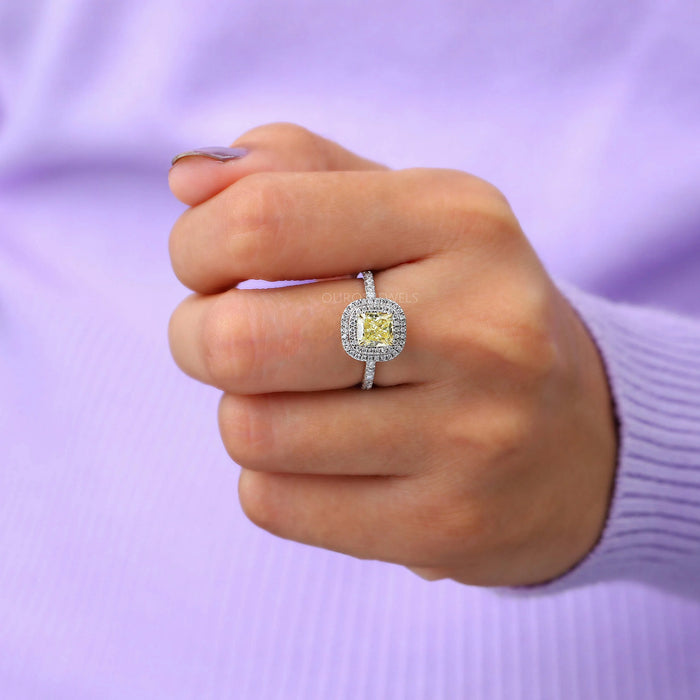 yellow cushion cut lab diamond double halo engagement ring in finger