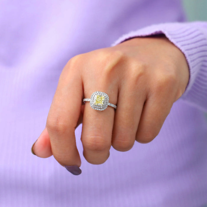 yellow cushion cut lab diamond double halo engagement ring on model's finger