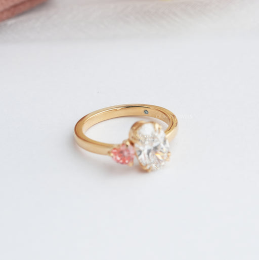 side view of oval and pink heart-cut lab-grown diamond toi et moi engagement ring