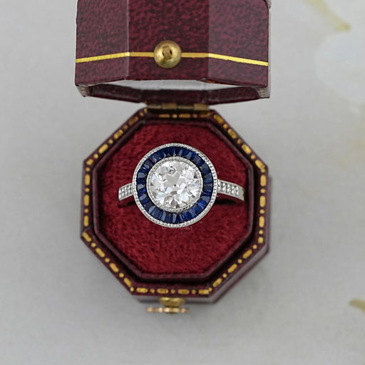 OEC round diamond surround with sapphire baguette halo wedding ring in jewelry box