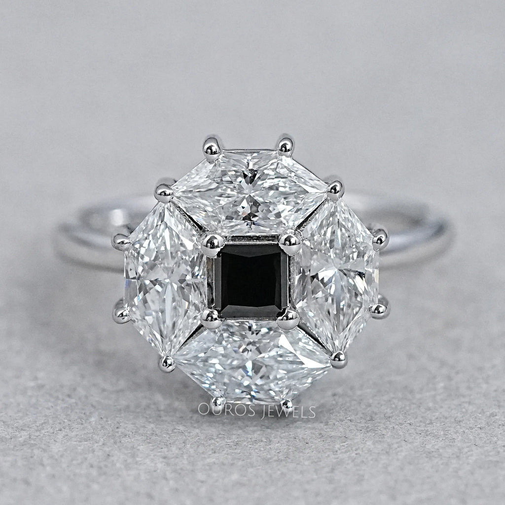 top view of princess cut lab diamond dutch marquise halo ring on grey fabric