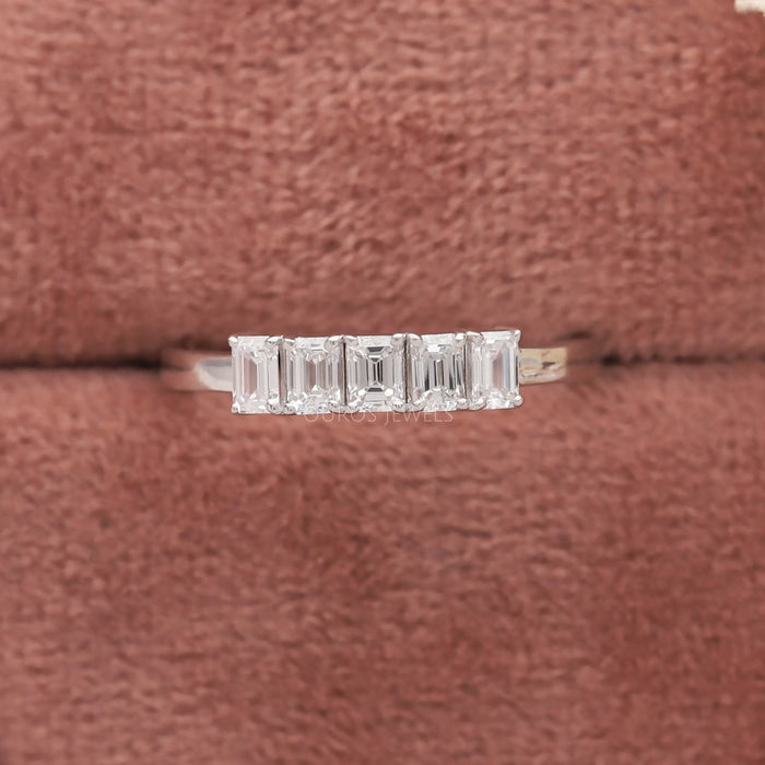 emerald-cut lab diamond five-stone wedding ring with white gold band in jewelry box