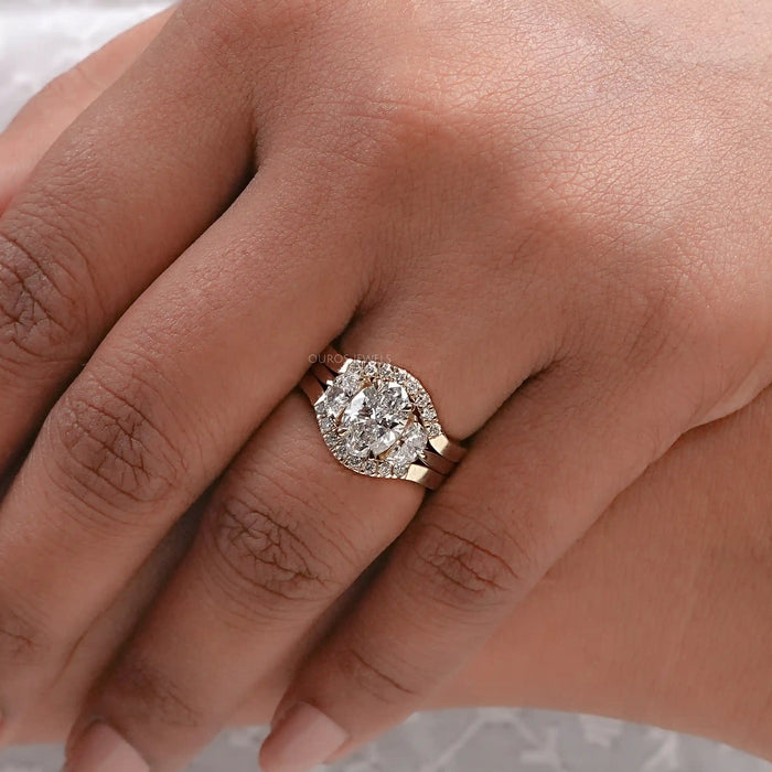 oval-cut lab diamond solitaire bridal ring set with yellow gold band in finger