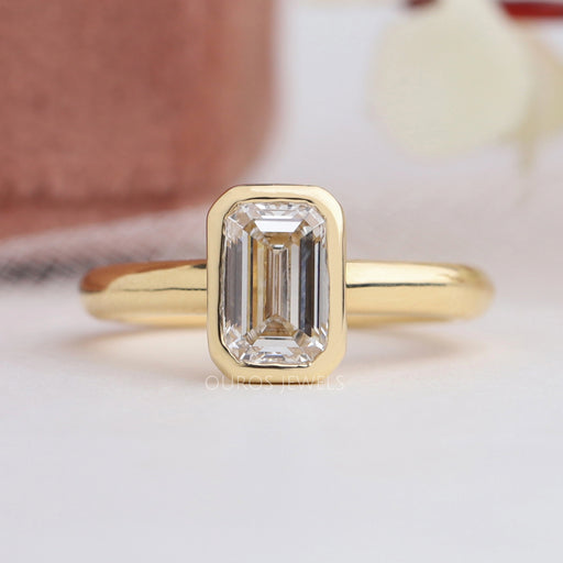 top view of emerald cut diamond bezel set solitaire engagement ring