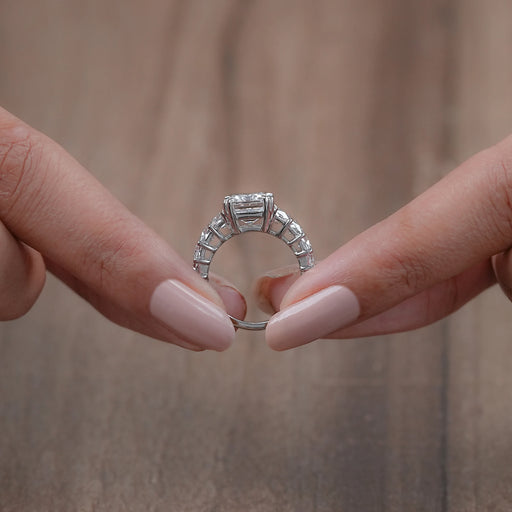 close view of emerald-cut lab diamond trapezoid solitaire accent engagement ring