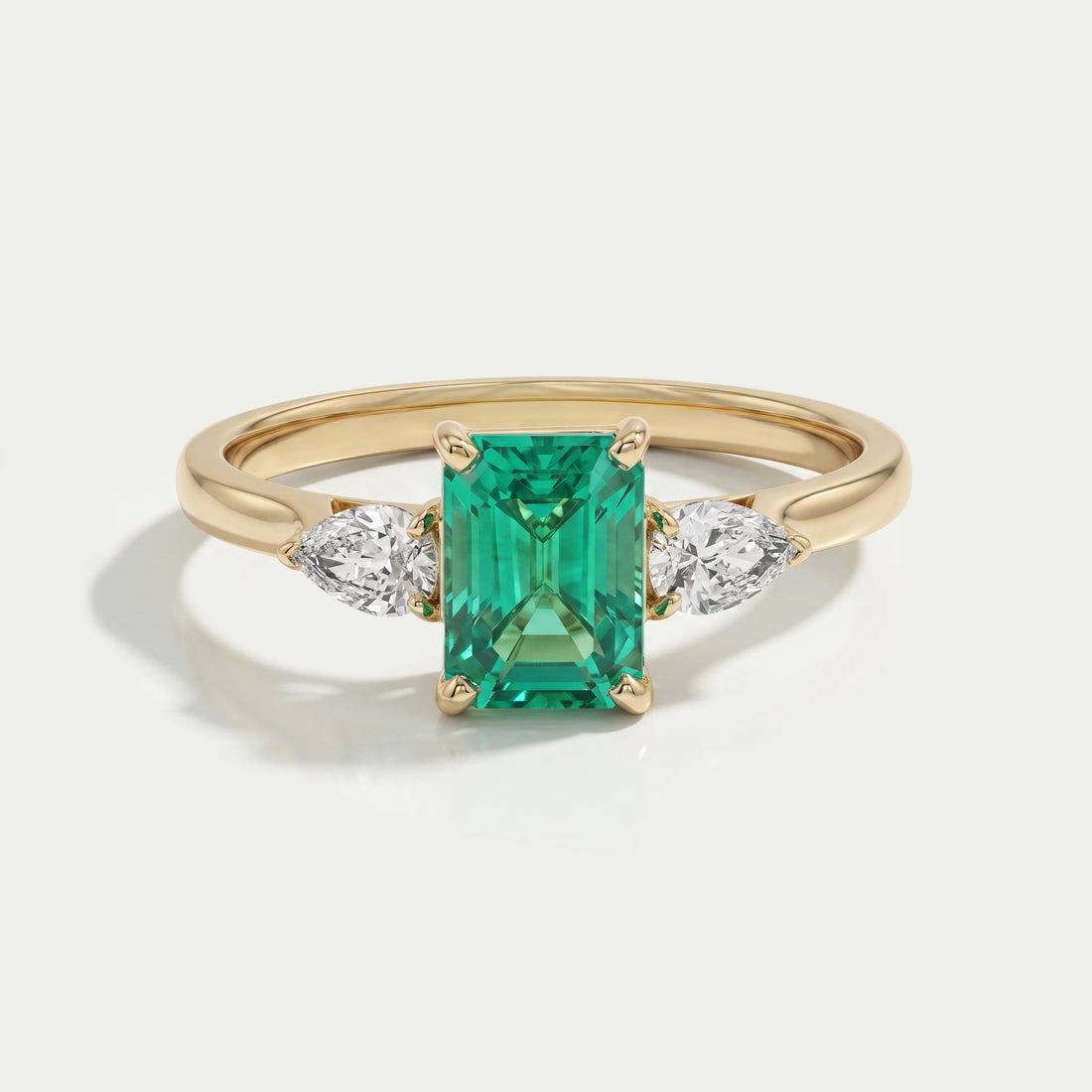 Emerald Gemstone And Pear Diamond Trio Engagement Ring Rings