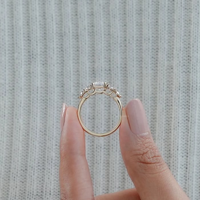 close view of emerald cut and round lab diamond five stone engagement ring