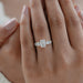 emerald cut and round lab diamond five stone engagement ring on model's finger