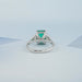 back view of green emerald gemstone with shield cut diamond 3 stone engagement ring