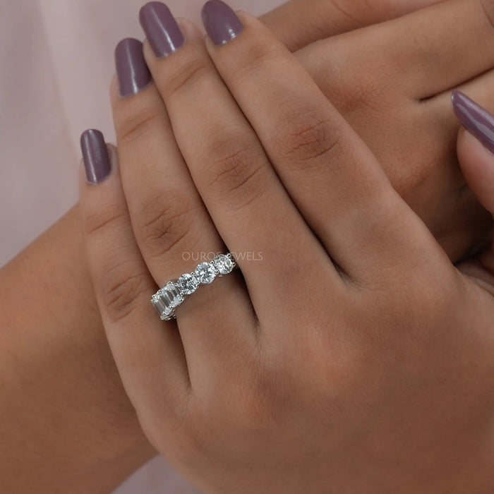 emerald and round shape lab created diamond full eternity ring on finger