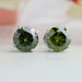 front view of green round cut lab grown diamond stud earrings white gold