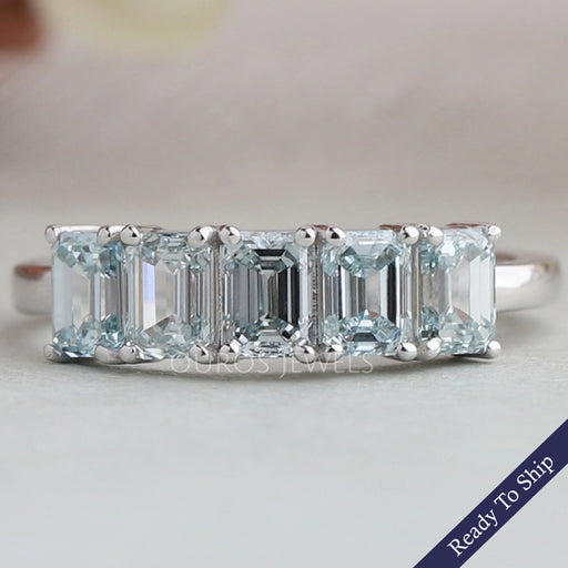 front view of light blue emerald cut lab diamond five stone wedding ring