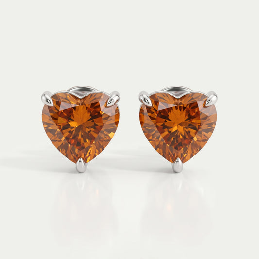 Boucles d'oreilles à tige avec solitaire en diamant et cœur rouge