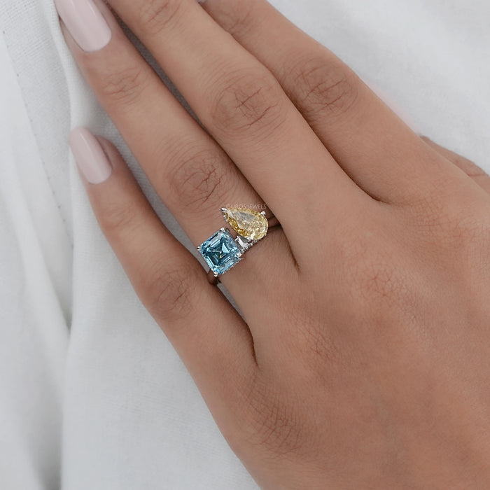 asscher and pear-cut diamond hidden halo toi et moi engagement ring in finger