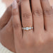 round and pentagon lab diamond bezel set five stone wedding ring on model's finger