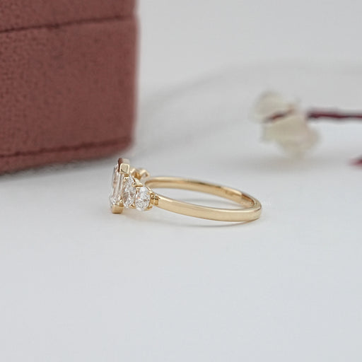 side view of emerald and oval cut diamond half bezel five stone engagement ring