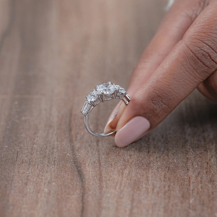 side view of round cut diamond five stone engagement ring with white gold band