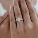 oval and round cut lab diamond five stone engagement ring on model's finger