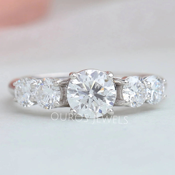 front view of round-cut diamond bezel-set curved wedding band with white gold band