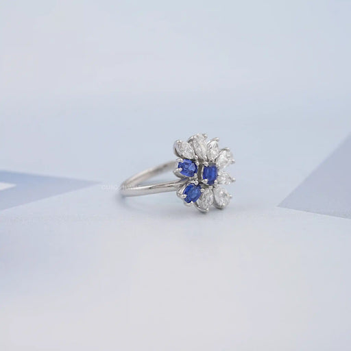 side view of blue sapphire oval cut gemstone cluster engagement ring