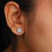 floral round cut halo diamond white gold stud earrings on ear