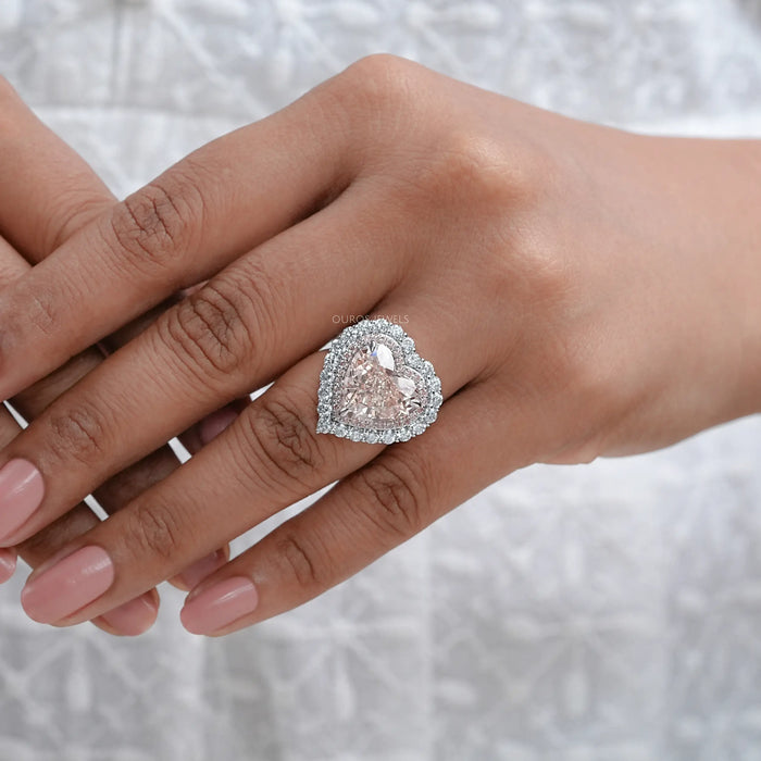 pink heart cut lab diamond double halo engagement ring on model's finger