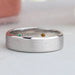 front view of round cut gemstone inside diamond wedding band white gold