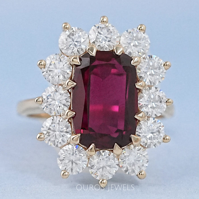 front view of ruby elongated cushion gemstone with round halo engagement ring